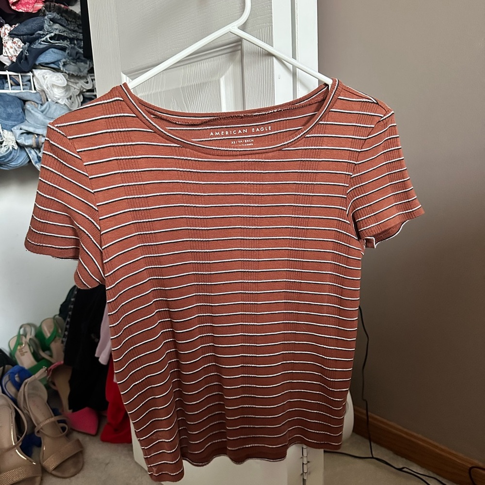 Selling a short sleeve fitting striped brown shirt from American Eagle.